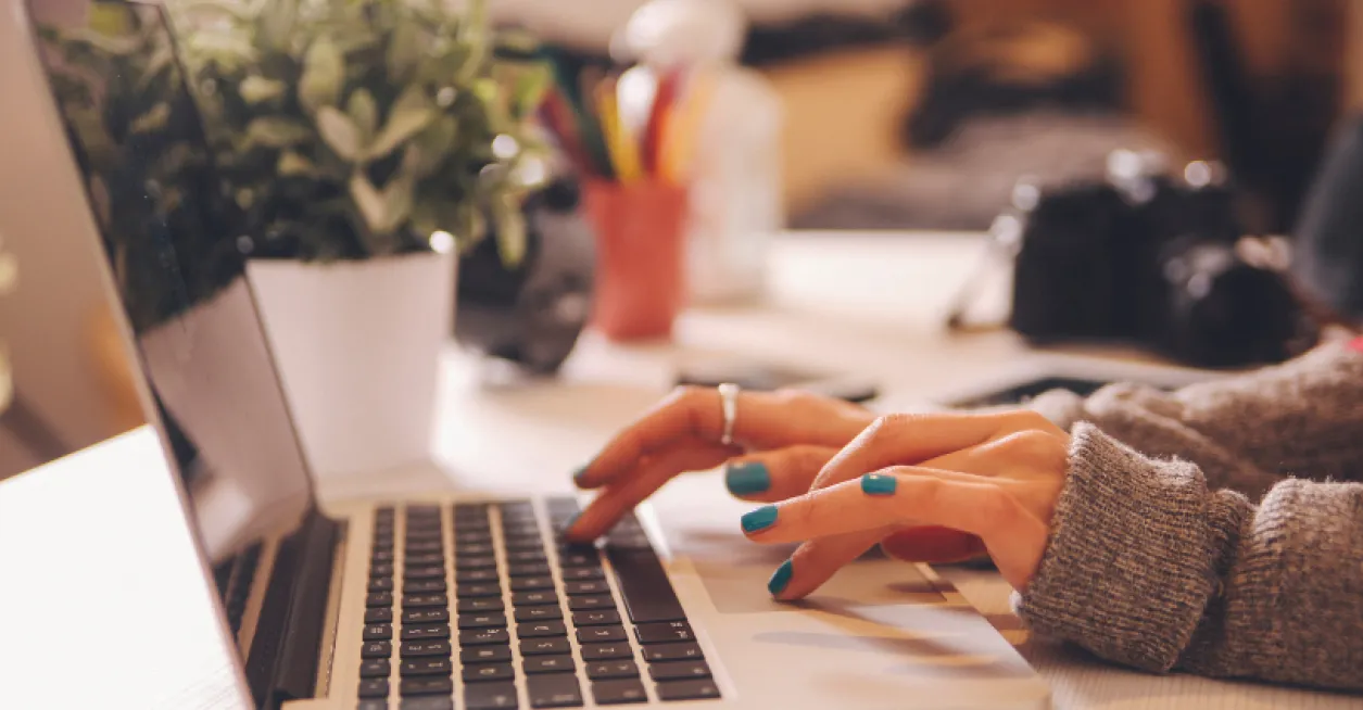 Woman typing on her laptop