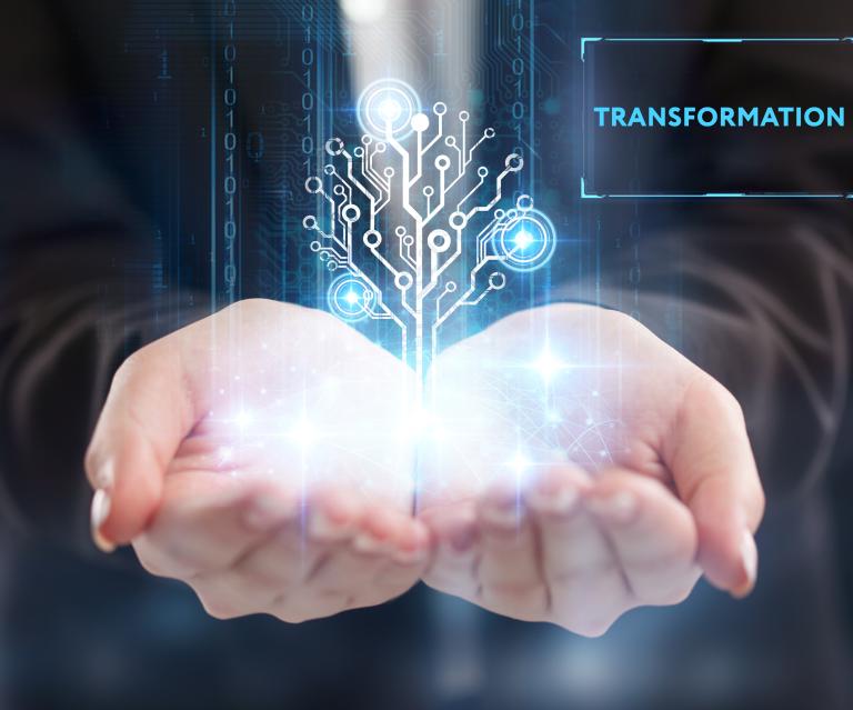 two cupped hands holding an image that conveys digital transformation