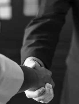 Two person shaking hands in grayscale photo