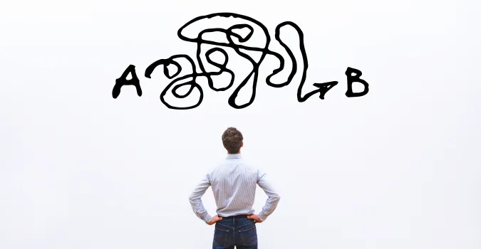 The back of a man looking at a white board with a big scribble black line between points A and B