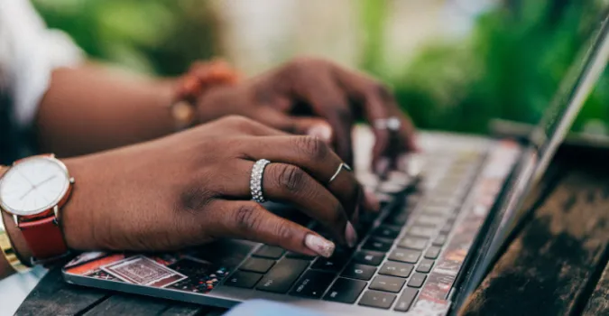 person typing on laptop