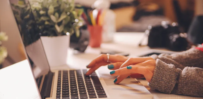 Woman typing on her laptop